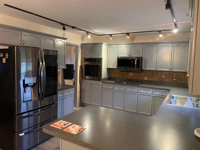 After: the same kitchen with gray painted cabinets