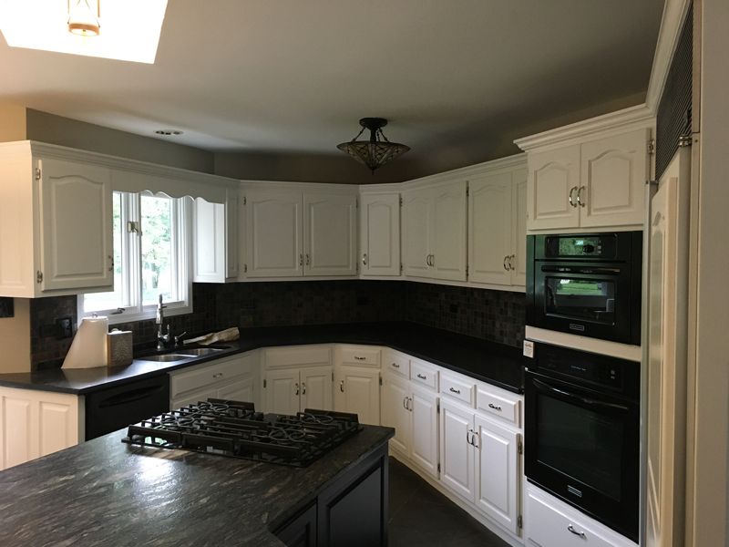 After: the same kitchen with the cabinets painted white
