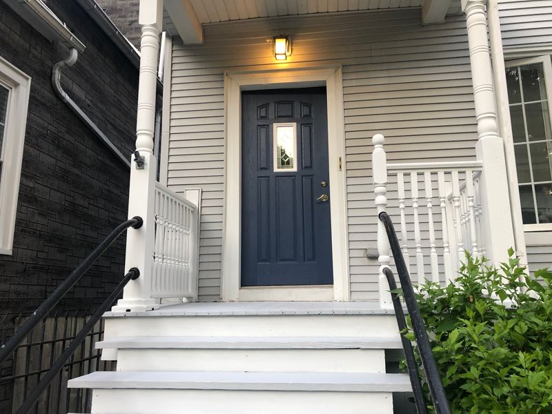 Front entry with navy door and white steps