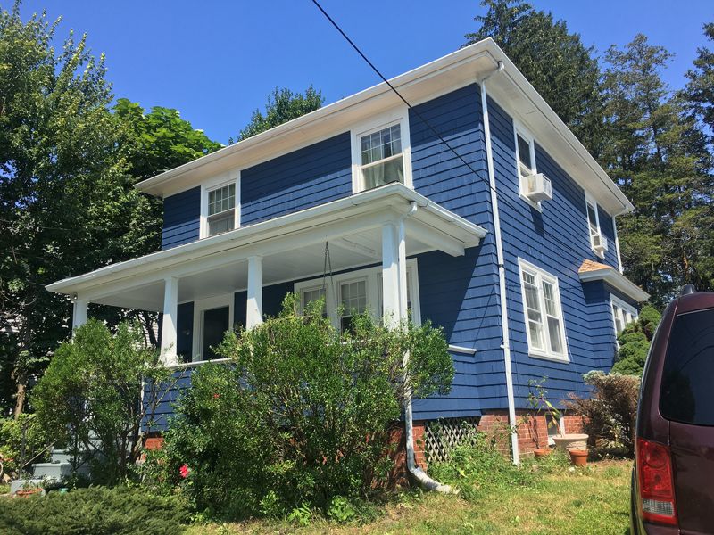 Two-story house with blue siding and white trim
