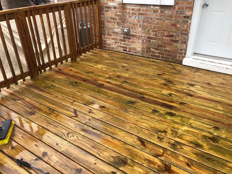 Wood deck during power washing